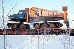 Juggernaut crane on a flatbed railroad car.