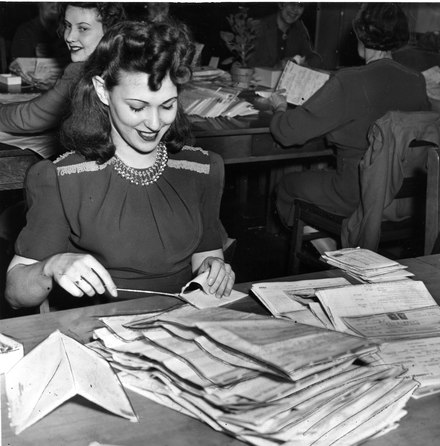 Department of National Revenue employee in Toronto opens and sorts tax returns, 1945. While women were hired into the federal civil service, they were required to resign upon marriage until 1955.