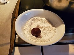 Rolling cookies in powdered sugar