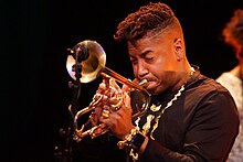 Trumpet player Chief Xian aTunde Adjuah wearing an Apple Watch Christian Scott aTunde Adjuah LV Rotterdam 19 november 2017 - Christian Scott (37656445105).jpg