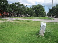 The Elysian Fields neutral ground, formerly the right-of-way of the Pontchartrain Rail-Road. The old mile-stone at the bottom right is one of the few surviving physical reminders of the long defunct railway. EFieldsPontchartrainRRStone1.jpg