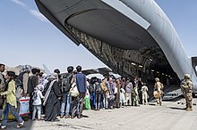 US soldiers with Afghans evacuating Hamid Karzai International Airport on 21 August, after the Taliban captured Kabul. Evacuation at Hamid Karzai International Airport 210821-F-IG885-1130.jpg