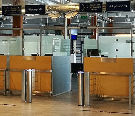 Border control booths in the departures hall at Oulu Airport in Finland, which will be staffed by the Finnish Border Guard when a flight is operated to a destination outside the Schengen Area. Either the 'EU/EEA/Swiss citizens' or 'All passports' sign above the booths can be illuminated.