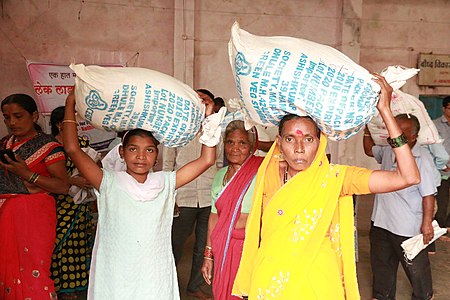 Flood affected families collecting grocery kits for survival