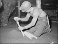 Harry Fain, coal loader, makes "stemmings" which are used in proper placing of powder charge. Inland Steel Company... - NARA - 541473.tif