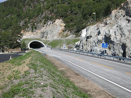 One of some 100 tunnels with standard two-lane undivided road. Yellow median line separates oncoming traffic