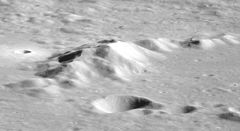 The central peak from Apollo 11. The highest peak is approximately 3.5 km above the crater floor. Keeler crater central peak AS11-38-5571.jpg