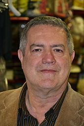 A headshot of a man with a blank expression