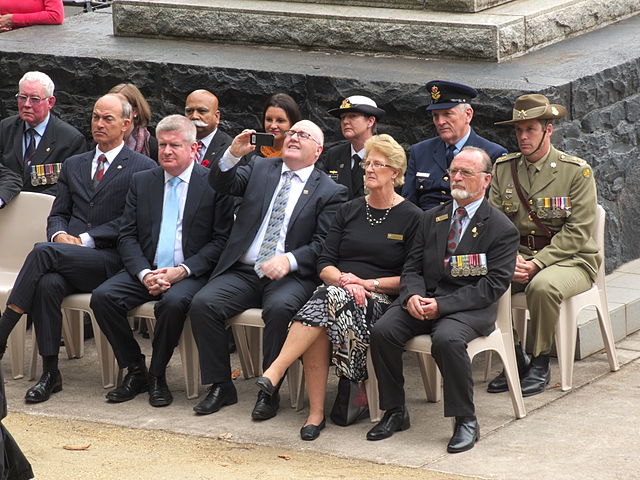Lambie (back row; middle) attending the unveiling ceremony for memorial wall and the Corporal Cameron Baird plinth in Burnie, Tasmania