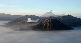 Mount Bromo at sunrise, showing its volcanoes and Mount Semeru (background).jpg
