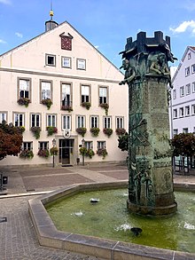 Rathaus und Brunnen, welcher im Relief die Stadtgeschichte zeigt (2018)