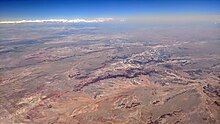 Aerial view looking south from the Navajo Reservation (foreground) across the Painted Desert, the Petrified Forest National Park, and Adamana, Arizona Navajo Reservation, Painted Desert, Petrified Forest National Park, and Adamana AZ aerial.jpg