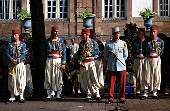 Modern French soldiers of the 1st Regiment of Tirailleurs - formerly recruited in Algeria and still retaining their historic ceremonial North African uniforms. Nouba 1er Regiment Tirailleurs Epinal.jpg