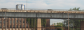 The George C. Platt Memorial Bridge is a through truss bridge that carries PA 291 (Penrose Avenue) over the Schuylkill River in Philadelphia, Pennsylvania. Eastern approach, showing rusting steel.