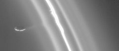 Close-up view of Prometheus and the F Ring. A movie of Prometheus at its apoapsis drawing a streamer of material out of the ring, leaving a dark channel, may be viewed here or here.