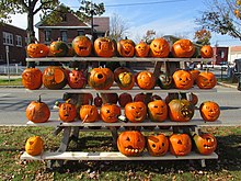 An assortment of carved pumpkins. Rack of pumpkins, Keene NH.jpg