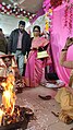 Sindur daan Hindu ritual as the groom is full blind ladies assisting her to complete rituals at Voice Of World Kolkata 06