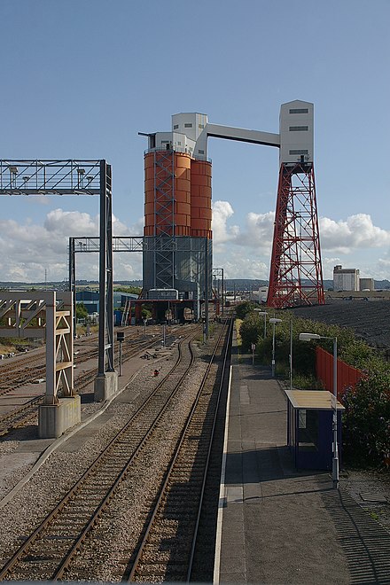 Despite being voted one of the most picturesque railway lines in the United Kingdom, the line from Bristol to Severn Beach also runs through the industrial area of Avonmouth. At St Andrews Road, a coal silo dwarfs the station.