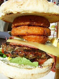 Steak burger with cheese and onion rings.jpg
