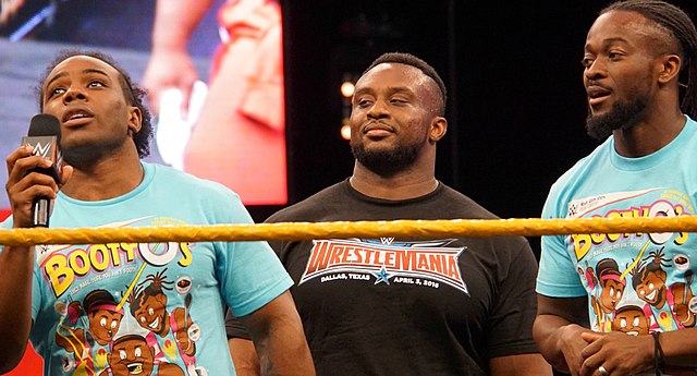 The New Day (from left to right: Xavier Woods, Big E, and Kofi Kingston) at WrestleMania Axxess in April 2016