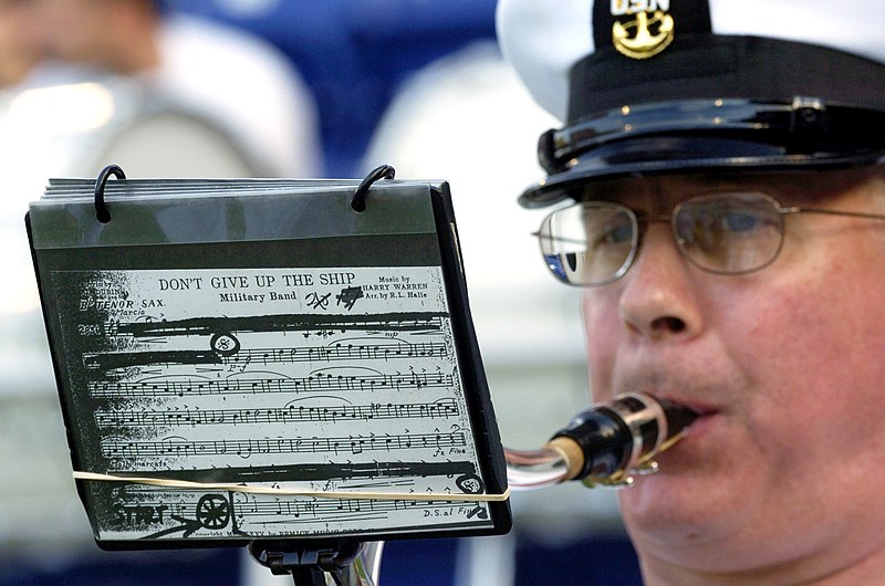 File:US Navy 040904-N-9693M-002 A U.S. Naval Academy Band musician plays a service song prior to the kick-off in the season home-opener football game.jpg