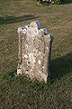 English: One of many old and unreadable stones at the graveyard of Vitaby kyrka in en:Sweden. Svenska: En av många gamla och oläsliga stenar på Kyrkogården vid Vitaby kyrka i Simrishamns kommun.