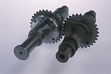 Figure 2: A helical camshaft shown for the intake on a Suzuki GSX 250 motorcycle engine, with a standard GSX camshaft for comparison. Wki cam photo 2.jpg