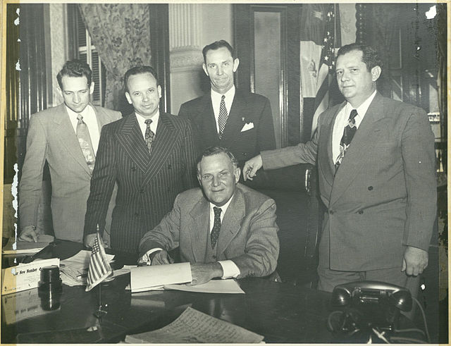 Rep. Jack Brooks is at the far left. Governor Beauford Jester is seated. Sen. W. R. Cousins is on the far right. Austin, Texas.
