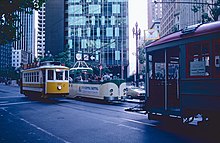 Porto 122, Blackpool "boat" 226 and Muni car 1 during a July 2 restaging of the 1983 Opening Day parade 1983 SF Historic Trolley Festival - Porto 122, Blackpool 226 and Muni 1 at Market & 1st.jpg