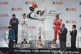 2014 Chinese Grand Prix - Lewis Hamilton holding winners' trophy with Nico Rosberg and Fernando Alonso.jpg