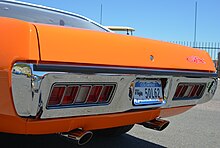 1971 GTX tail light panel with factory slotted exhaust tips
