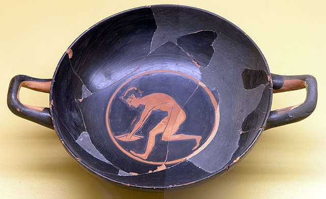 Greek athlete with halteres, running before a long jump - Greek Halteres