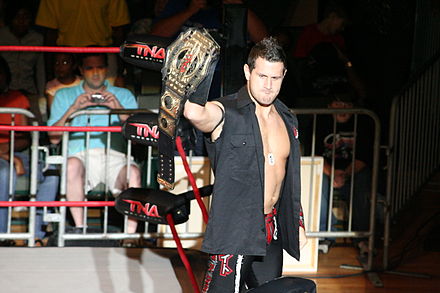 Shelley posing with a TNA World Tag Team Championship belt