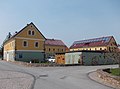 Residential stable house, barn, side building and gate entrance of a former four-sided courtyard