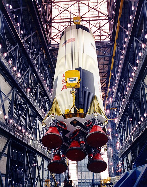 The Apollo 10 S-IC stage is hoisted in the VAB for stacking