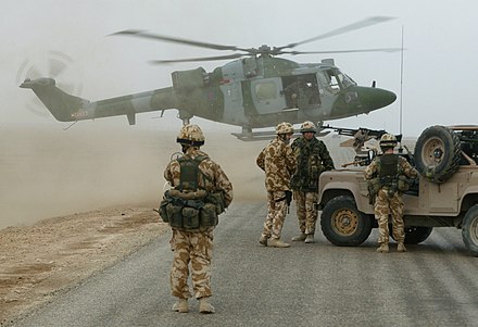 A Lynx Helicopter of the British Army Air Corps ready to touch down on a desert road south of Basra Airport, November 2003