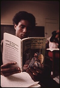 A Chicago Public Schools student on the West Side in 1973 reading a book on rulers throughout African history. BLACK STUDENT IN A BLACK STUDIES CLASS IN A WEST SIDE CHICAGO CLASSROOM READING A BOOK ABOUT GREAT RULERS IN AFRICA'S... - NARA - 556263.jpg