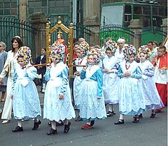 Corpus Christi procession in Poznań, Poland, 2004: little girls carrying an Infant Jesus of Prague statue, followed by altar servers clothed in surplice and cassock