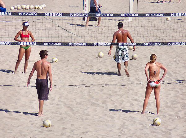 An amateur mixed doubles match of beach volleyball