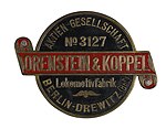 Brass round badge shaped locomotive builders plate, No. 3127, manufactured by Orenstein & Koppel Lokomotivfabrik AG, Berlin-Drewitz, circa 1908.jpg