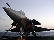 Rafale fighter on the flight deck of Charles de Gaulle at dawn