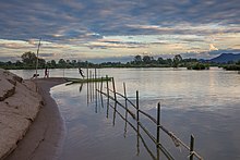 Children playing at sunset on a Mekong bank in Si Phan Don.jpg