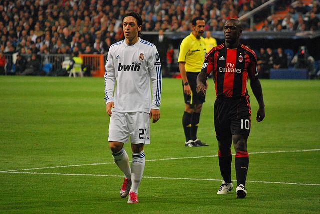 Seedorf playing against former club Real Madrid. On the left is Mesut Özil.