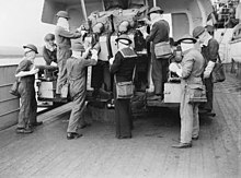 Crew of a dual 4-inch at action stations aboard HMS Berwick while in screening the Atlantic Convoys in May 1943. Cruiser Guns' Crews. May 1943, on Board HMS Jamaica and Berwick. A16318.jpg