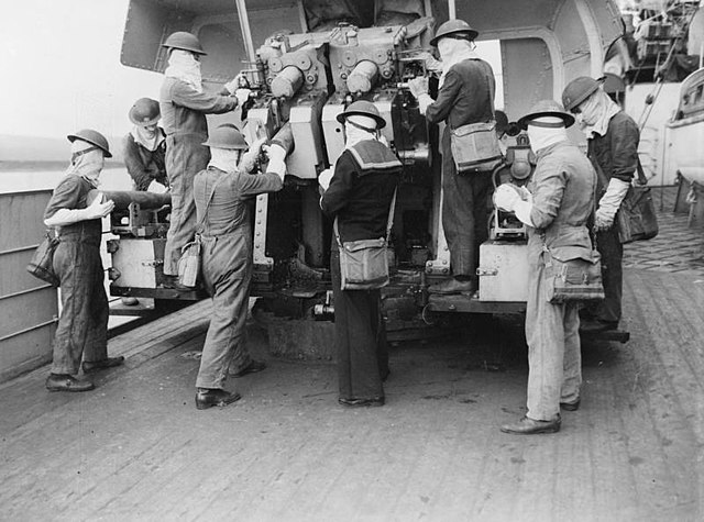 Crew of a dual 4-inch at action stations aboard HMS Berwick while in screening the Atlantic Convoys in May 1943.