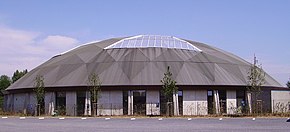 The structure has a round roof with a large skylight