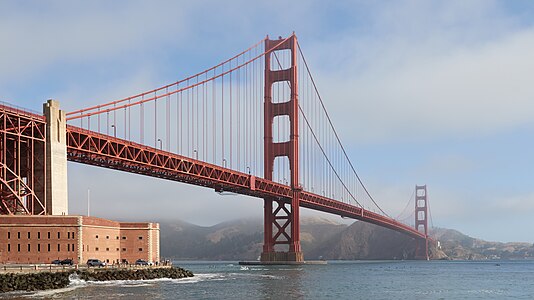 The Golden Gate Bridge on an early morning in June 2017 as seen from the Fort Point side. The sun slowly dissolves the fog that’s covering the Marin Headlands and parts of the bridge.