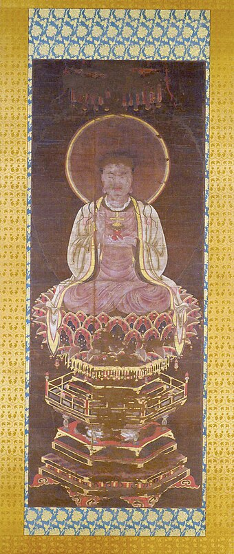 Manichaean Painting of the Buddha Jesus depicts Jesus Christ as a Manichaean prophet. The figure can be identified as a representation of Jesus Christ by the small gold cross that sits on the red lotus pedestal in His left hand.
