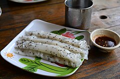 Rolled khao phan with black sesame seeds