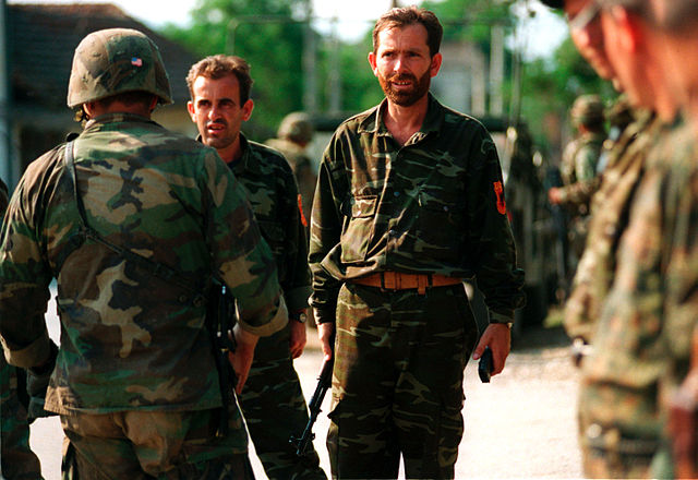 Kosovo Liberation Army handing over arms to U.S. forces, 30 June 1999